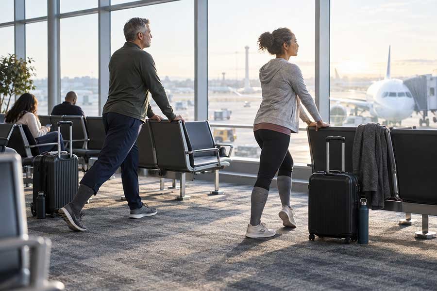 Comfortable travel clothing and compression socks packed for a flight