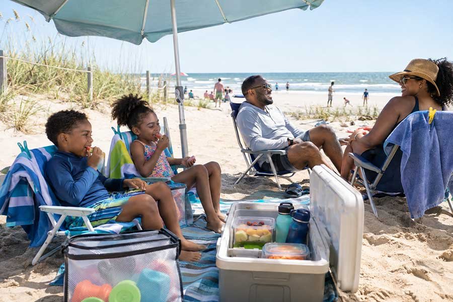 Parents taking turns watching kids at the beach