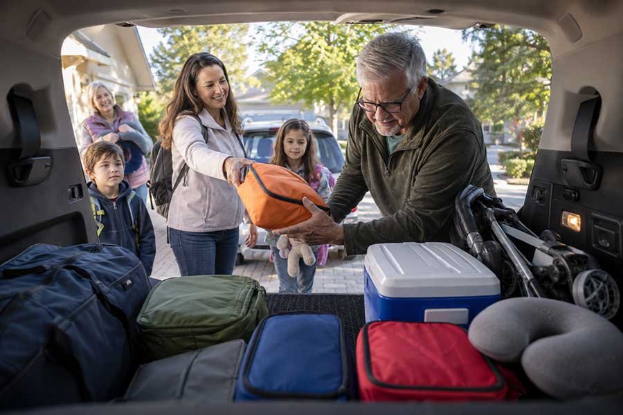 A family packing the car for a road trip
