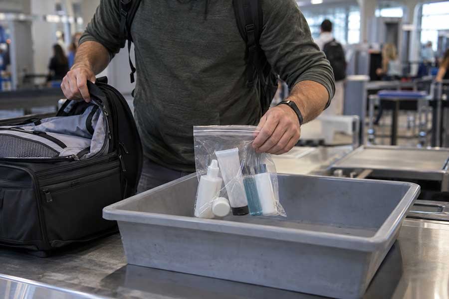 Sealed duty-free liquid bottle in a tamper-proof bag with receipt