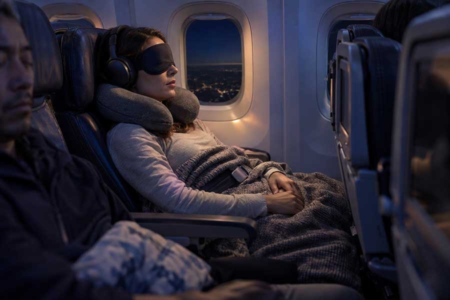 A traveler comfortable in an economy class seat