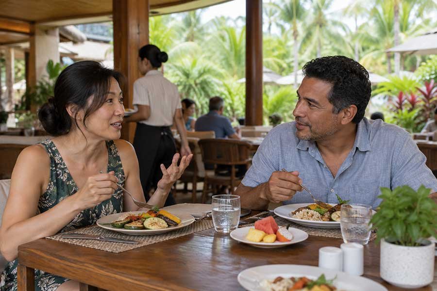 Guests enjoying a relaxed meal at a resort restaurant overlooking the garden