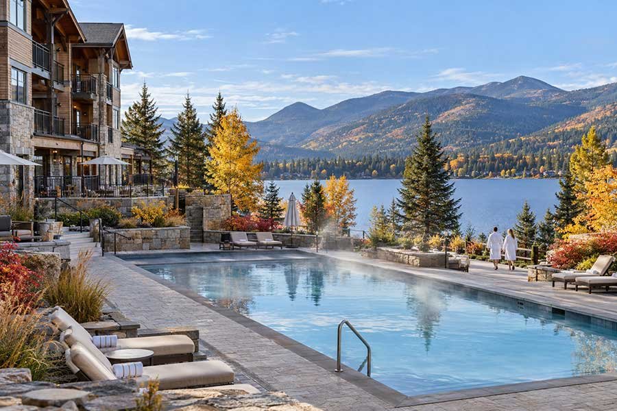 Autumn lakeside resort with a calm lake, fall trees, and an inviting resort building