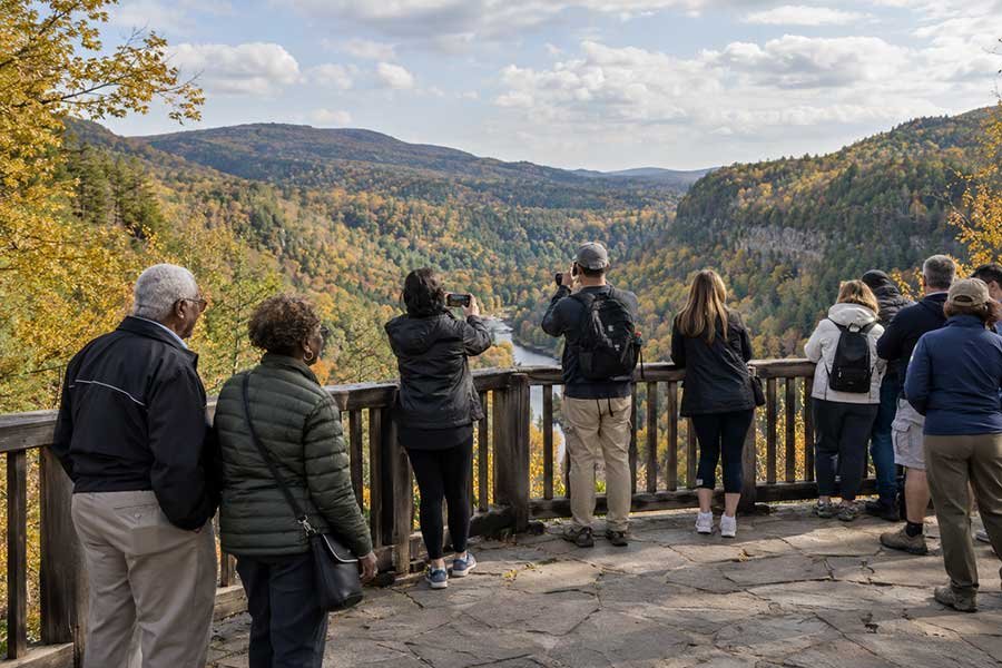Crowded fall foliage overlook with many visitors on a peak weekend
