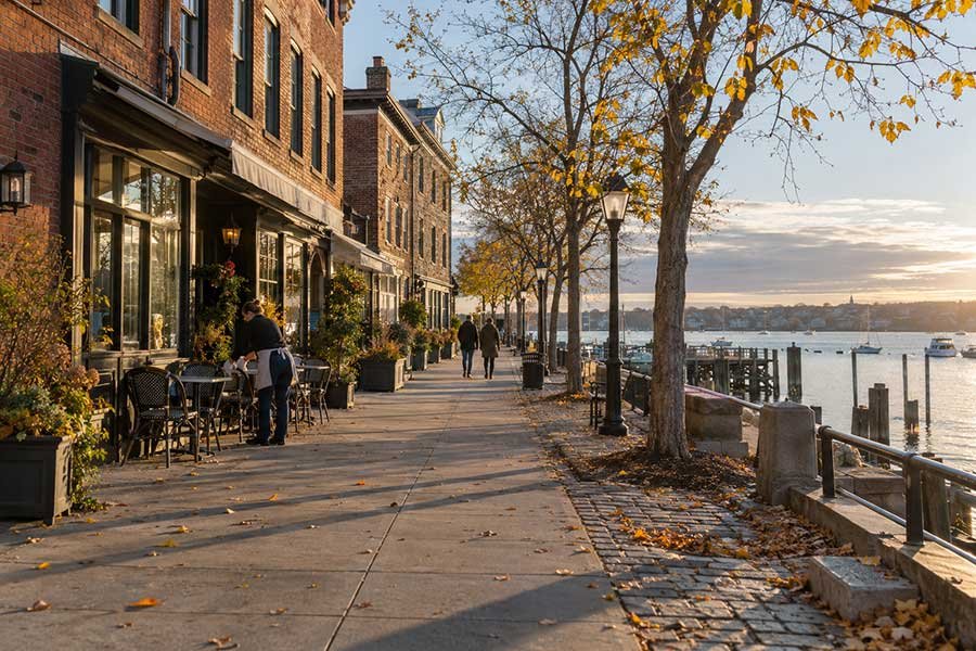 Late autumn morning by a waterfront with soft early light on the water and fall trees