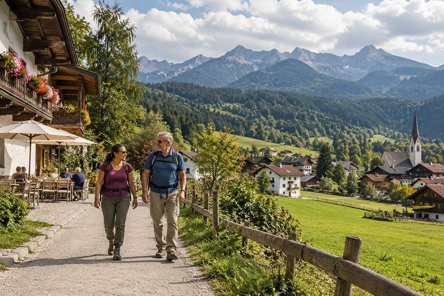 Quiet stroll through an Austrian Alpine village with mountains rising behind painted houses